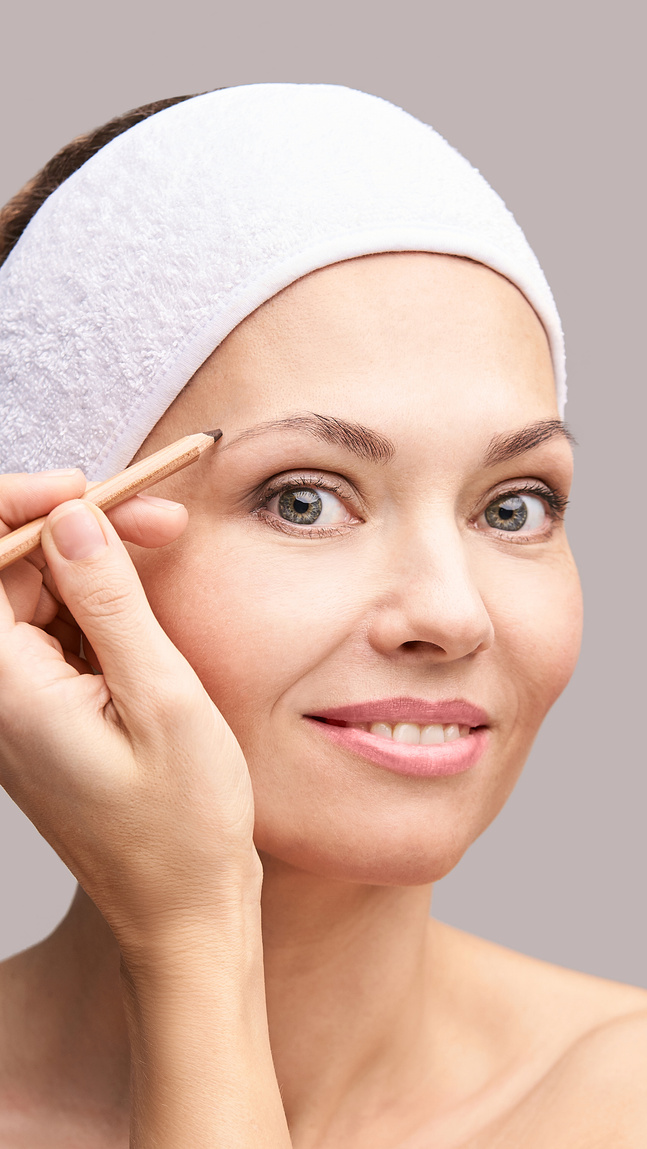 Woman Grooming Her Eyebrows     